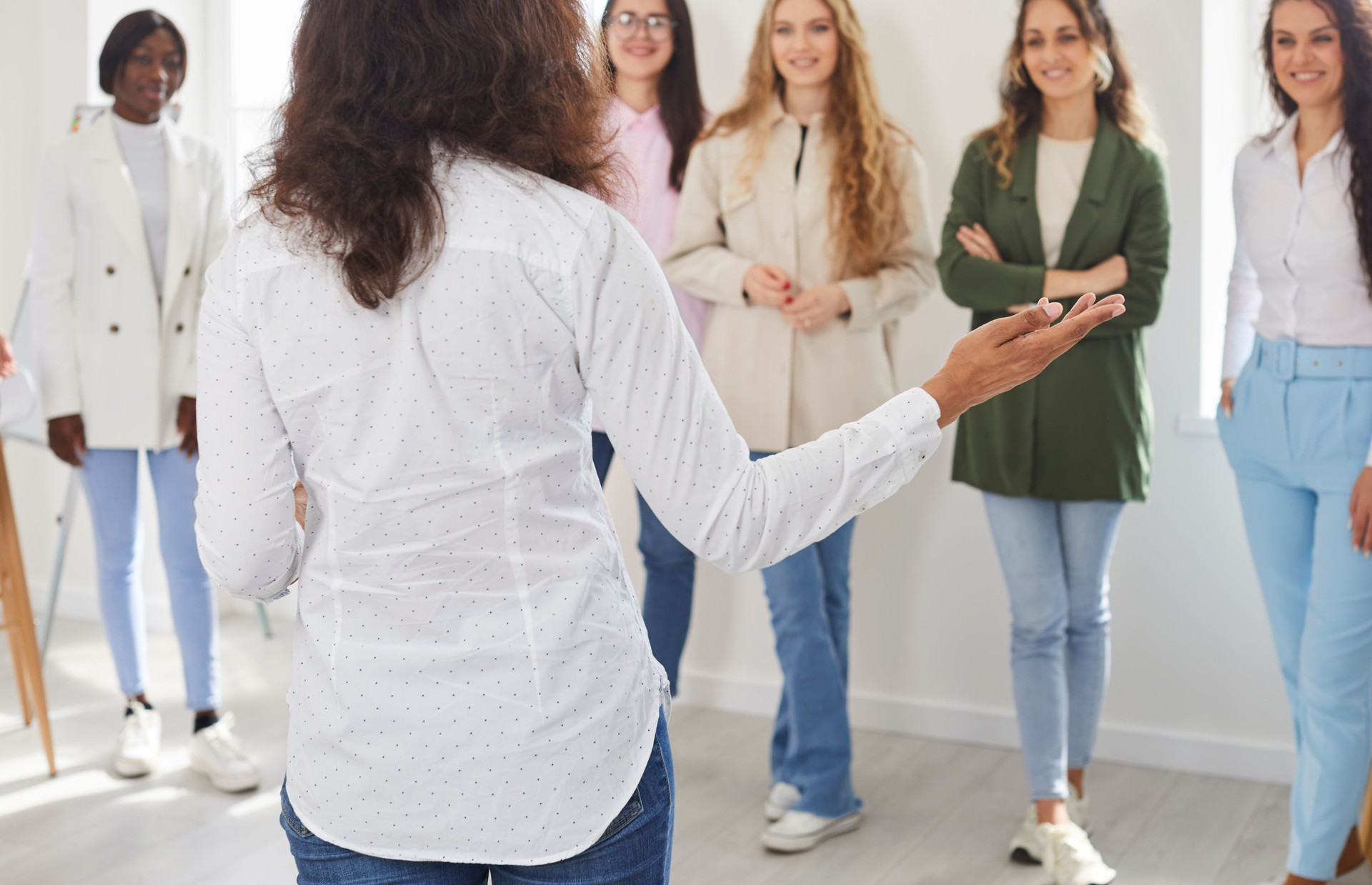 Business coach, psychologist or corporate manager meeting with team of young women